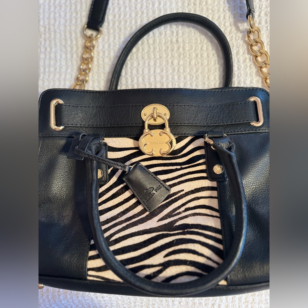 Emma Fox shoulder bag with zebra and gold metal accents.